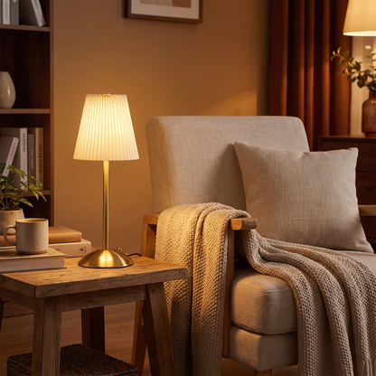 Pleated cordless lamp by an armchair (styled photo)