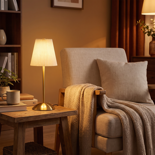 Pleated cordless lamp by an armchair (styled photo)